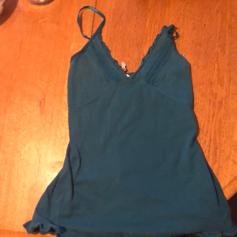 blue shirt with some ruffles on it